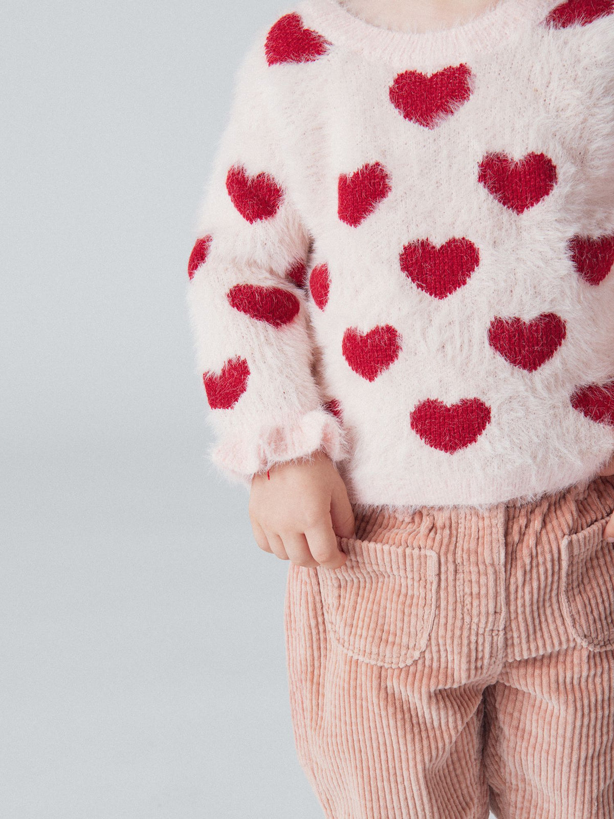 Suéter rosa tiza con patrón de corazones para niña bebé