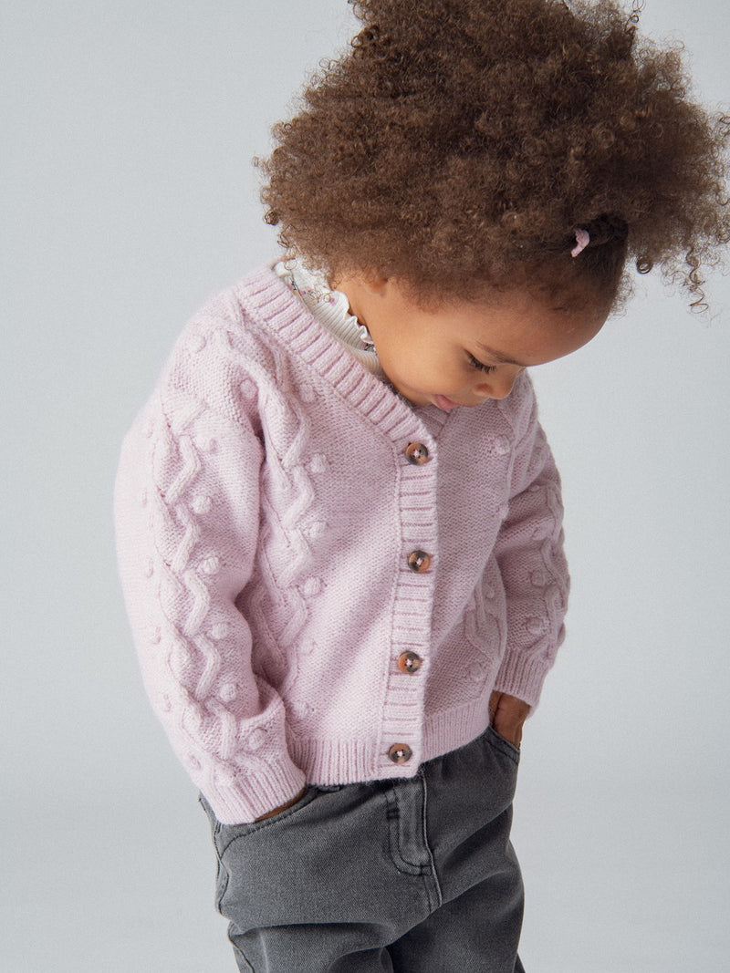 Cardigan de punto retorcido rosa para niña