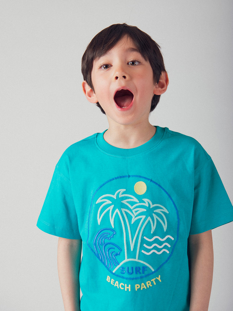 Camiseta azul turquesa con animación de playa para niño