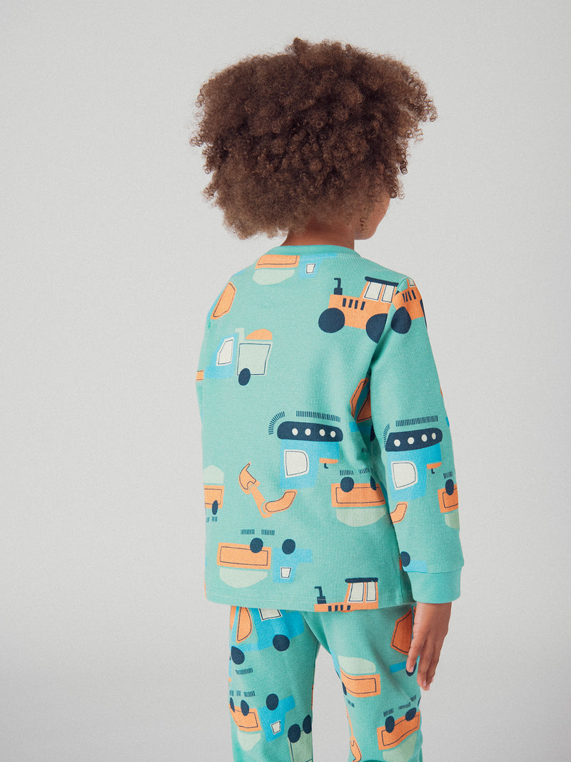 El pijama de 2 piezas verde con estampado "Construcción" para bebé niño