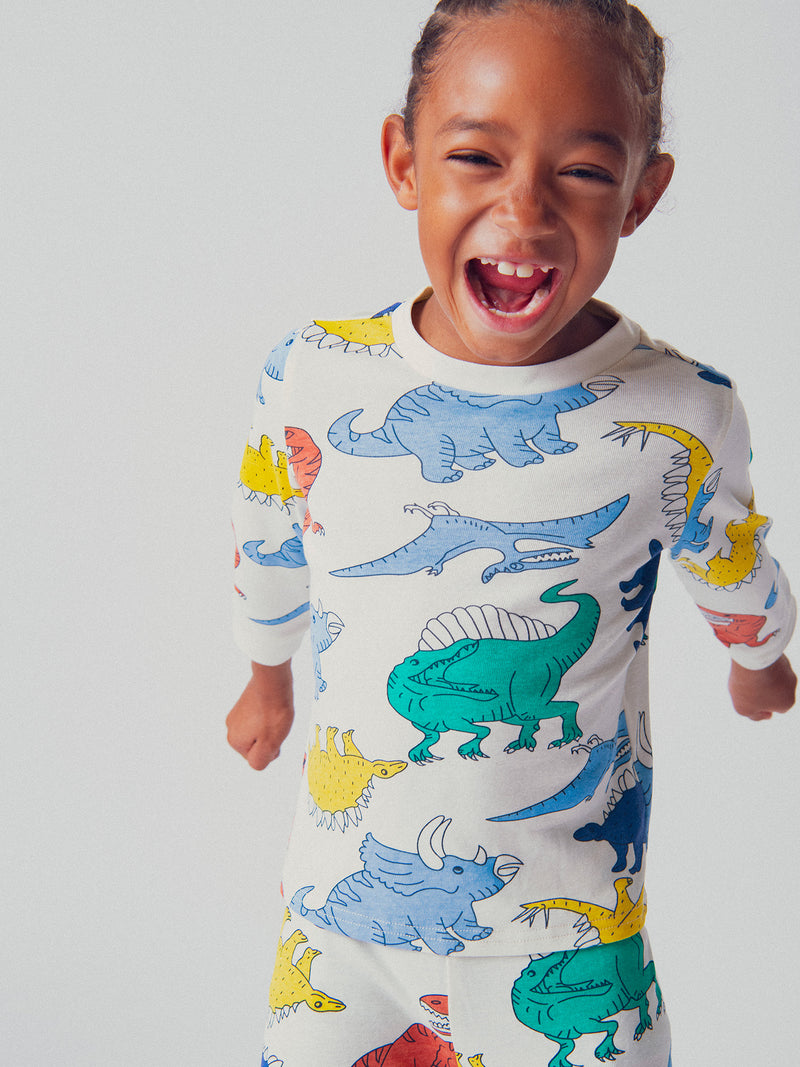 Pijama ecru con imágenes de dinosaurios para niños